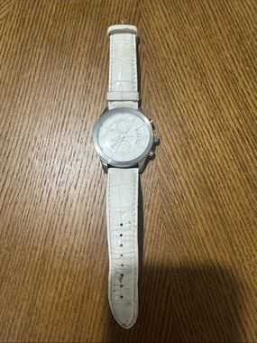 Guess men’s white leather strap watch